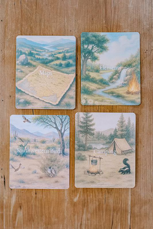 Image of four cards laying on a wooden table.